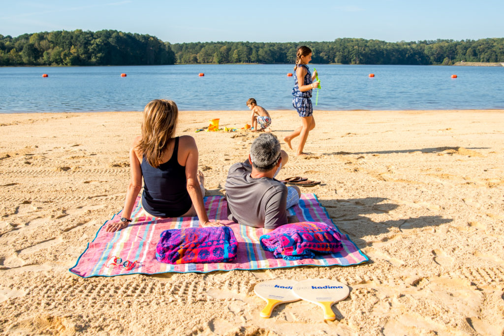 parents watching their children play on the beach at Lake Acworth