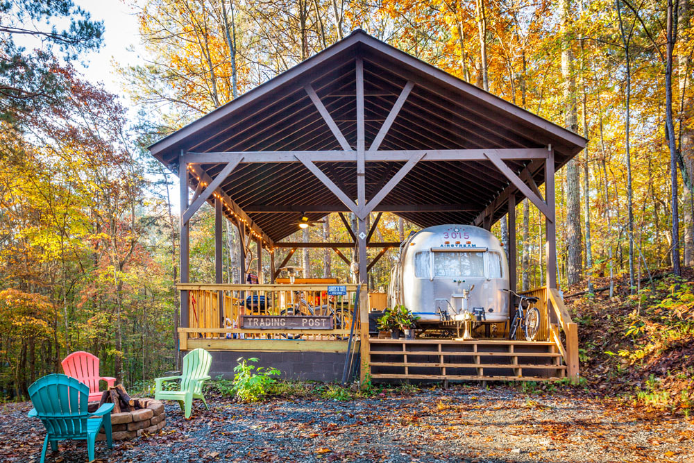 charming and retro Airstream parked underneath a spacious porch