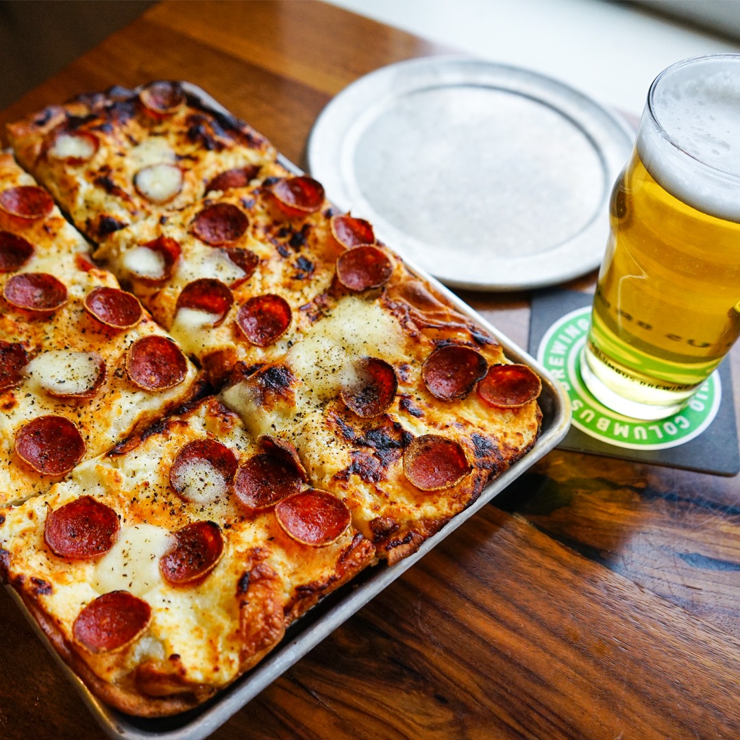 pepperoni pizza served with craft beer